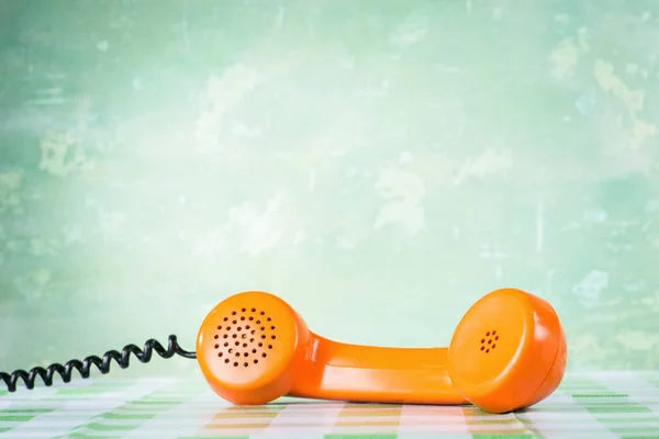 Orange handset on table — Stock Photo, Image