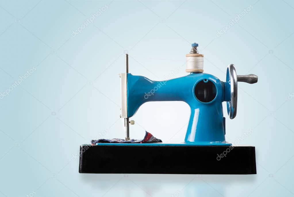 Sewing machine on a blue background, close up