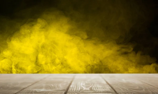 Empty tabletop against a background of yellow smoke — Stock Photo, Image