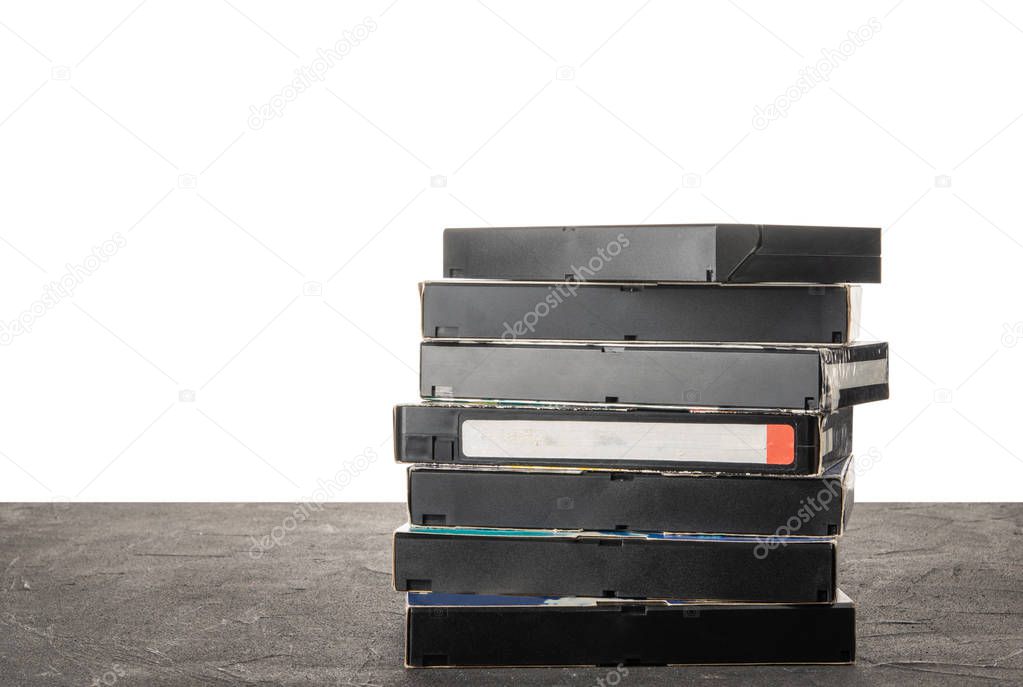 VHS videotape on a black table with isolated background