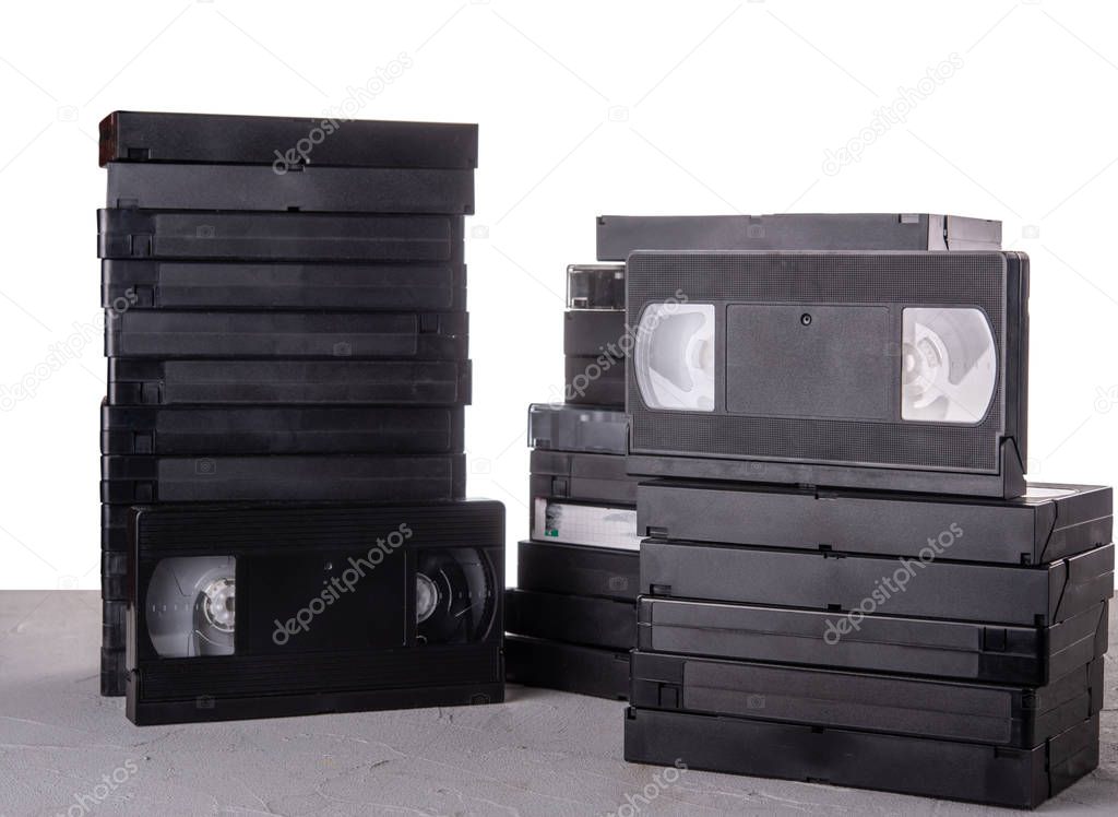 Many VHS video cassettes on the desk with isolated background