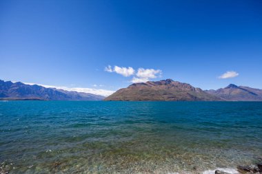 Beautiful landscape with high rocks with illuminated peaks, New Zealand.
