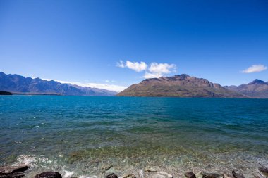 Beautiful landscape with high rocks with illuminated peaks, New Zealand.
