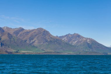 Beautiful landscape with high rocks with illuminated peaks, New Zealand.