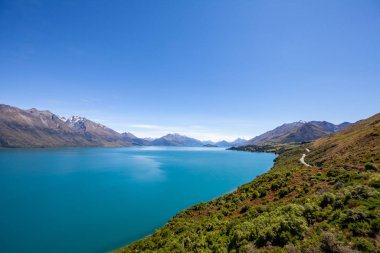 Beautiful landscape with high rocks with illuminated peaks, New Zealand.