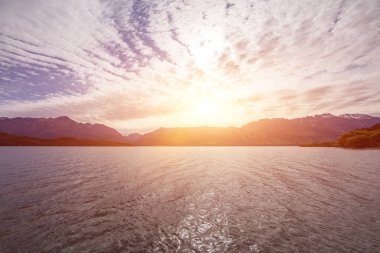 Beautiful landscape with high rocks with illuminated peaks, New Zealand.
