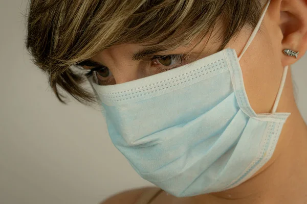 Portrait of young woman with mask on face