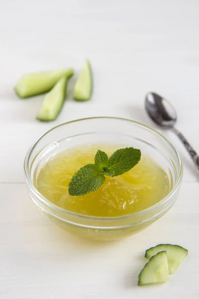 Cucumber jam in a transparent bowl on a white background