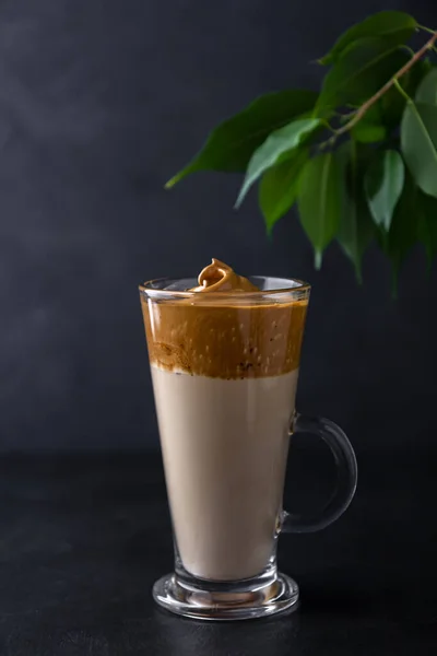 Dalgona coffee in a glass cup on a black background — Stok Foto