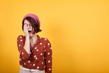 Yorgun, genç, esneyen Kafkasyalı suratının yarısını eliyle kapatarak sıkılmış görünüyor..