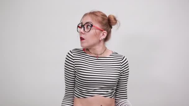 Young woman in striped looking shocked, nervous and scared, keeping hands — Stock Video