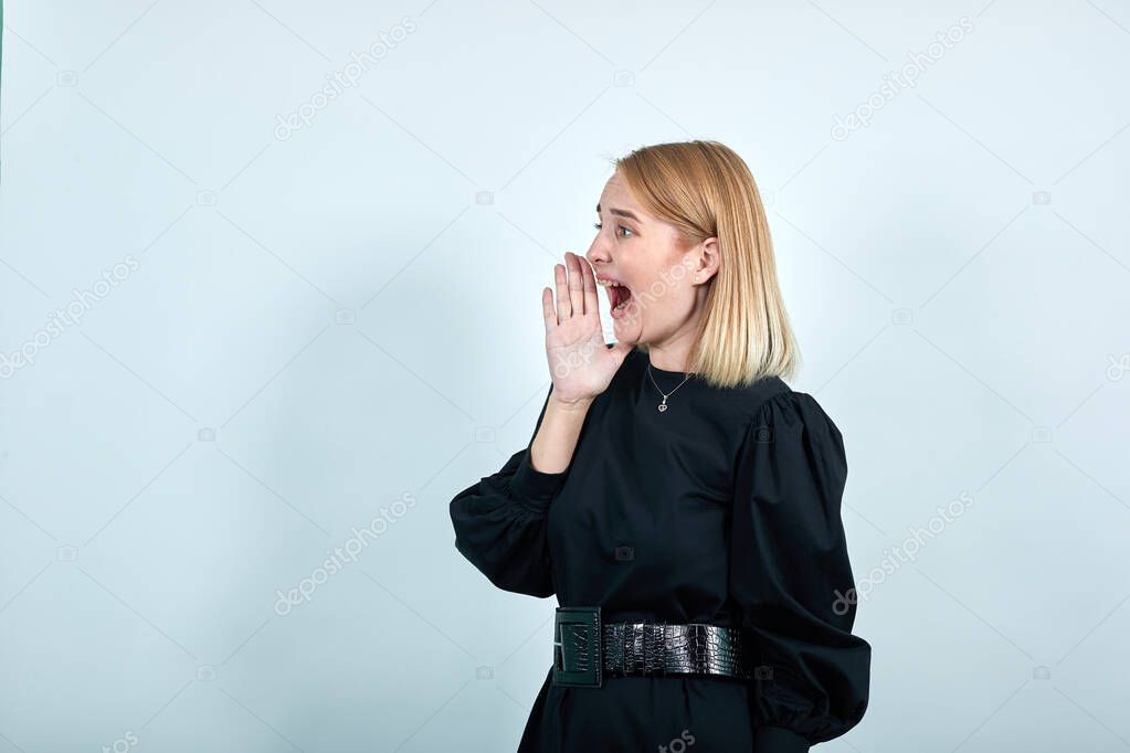 Young sad frustrated worried unshaven woman in black dress looking camera