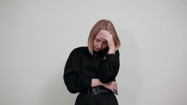 Portrait of tired young lady keeping eyes closed and putting hand on nose — Stock Video