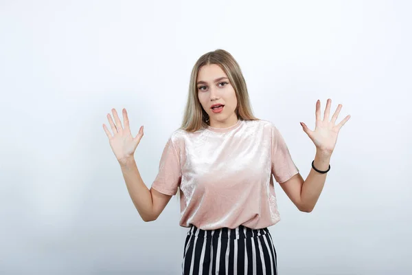 Portrait de jeune femme choquée en vêtements décontractés, les mains levées montrant la paume . — Photo