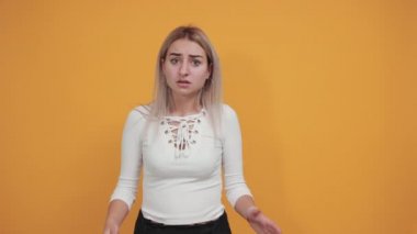 Çekici, genç ve güzel bir kadın hayal kırıklığına uğramış görünüyor ve ellerini kafasından tutuyor.