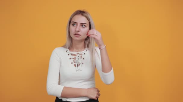 Uttråkad ung kvinna i casual kläder hålla ögonen öppna, med handen bakom huvudet — Stockvideo
