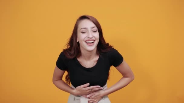 Caucasian young lady smiling, laughting keeping hand on stomach and waist — Stock Video