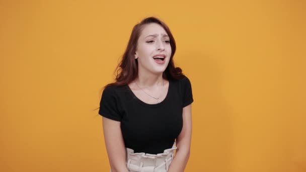 Attraktive junge Frau zeigt direkt in die Kamera, lächelt, sieht glücklich aus — Stockvideo