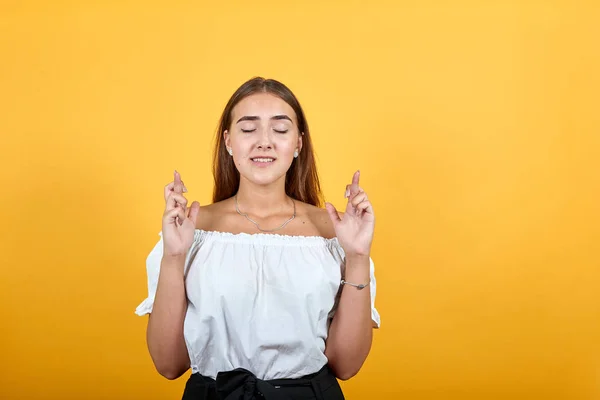 快乐的年轻女子手指头交叉，等待着特别的时刻 — 图库照片