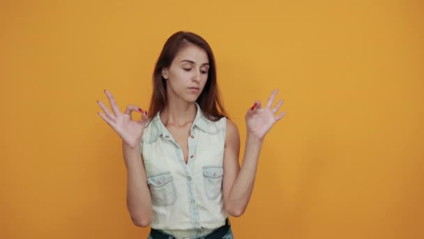 Ruhige kaukasische Frau in blauem Jeanshemd macht okay Geste, sieht hübsch aus — Stockvideo