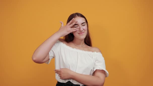 Aantrekkelijke vrouw die het oog bedekt met de hand, kijkend door vingers, geopende mond — Stockvideo