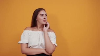 Hayal kırıklığına uğramış genç bir kadın başparmağını kaldırıyor, ciddi görünüyor.