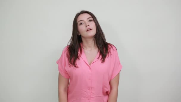 Sick young woman keeping hand on head, headache isolated on gray wall — Stock Video