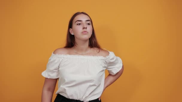 Confused young woman keeping hand behind back, looking disappointed — Stock Video