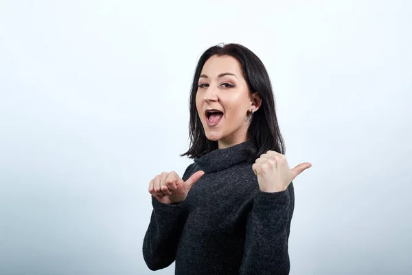 stock image Cheerful caucasian young woman smiling, pointing thumbs aside Lifestyle concept.