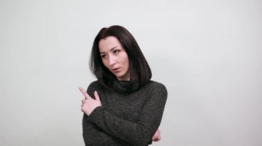 Ciddi bir kadın ellerini çenesinde tutuyor, bir şeyler düşünüyor.