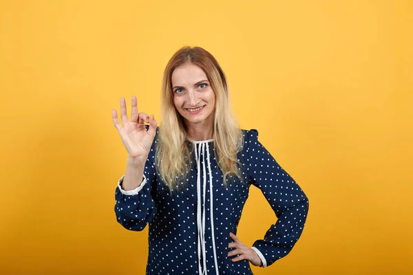 Mujer joven sonriente mirando directamente, haciendo buen gesto —  Fotos de Stock