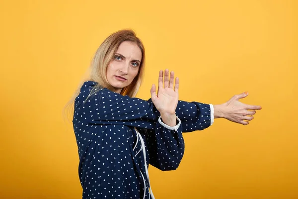 Ernste kaukasische Dame bleibt seitlich stehen, streckt die Hände aus und macht Stop-Geste — Stockfoto