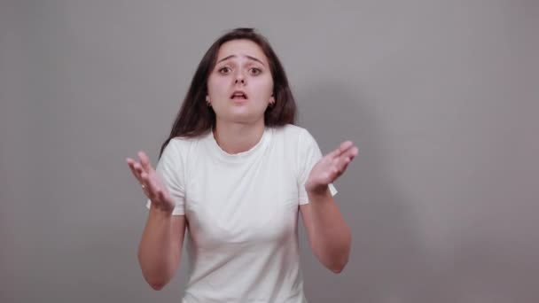 Tired woman in white shirt keeping hands on forehead, looking unhappy — ストック動画