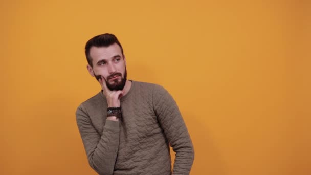 Boring man keeping hands on cheek, beard, looking tired wearing casual clothes — Stock Video