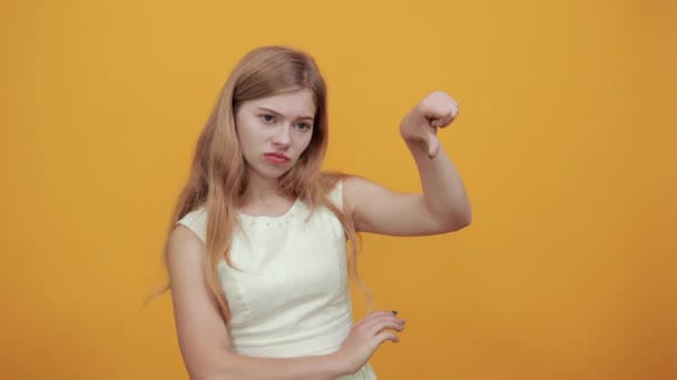 Teleurgesteld jonge vrouw houdt duimen naar beneden, kijkt ontevreden — Stockvideo