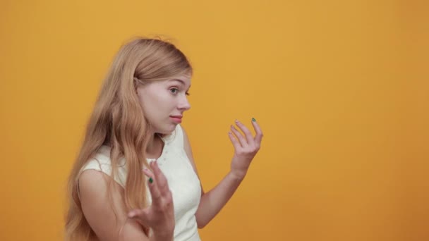 Csalódott bájos szőke fiatal nő kezet nyújt, zavarodottnak tűnik. — Stock videók