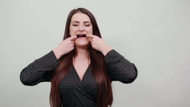 Charming caucasian woman stretches mouth with fingers. — Stock Video