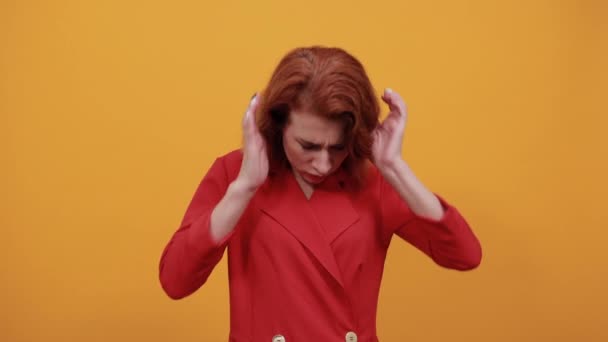 Disappointed caucasian young woman looking aside, covered ears with fingers — Stock Video