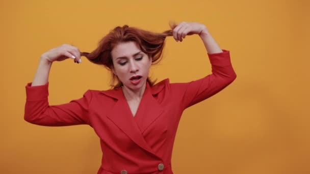 Vit ung kvinna vrider håret runt fingrarna, korrigerar frisyr — Stockvideo