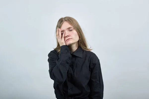 Tired young woman in fashion black shirt keeping hand on head, closed eyes. — 스톡 사진
