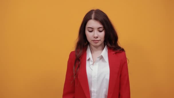 Νεαρή γυναίκα με λευκό πουκάμισο μόδας και κόκκινο μπουφάν κοιτάζει κάτω, δείχνει μανικιούρ — Αρχείο Βίντεο