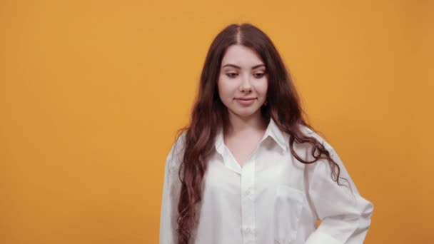 Woman in fashion white shirt covering eyes with hand, having curly haircut — Stock Video