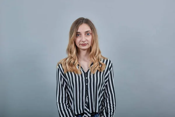 Charming woman in black and white striped shirt looking at camera, smiling — Stock Photo, Image