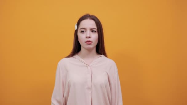 Caucasian brunette woman in pastel shirt keeping hands on head, having headache — 비디오