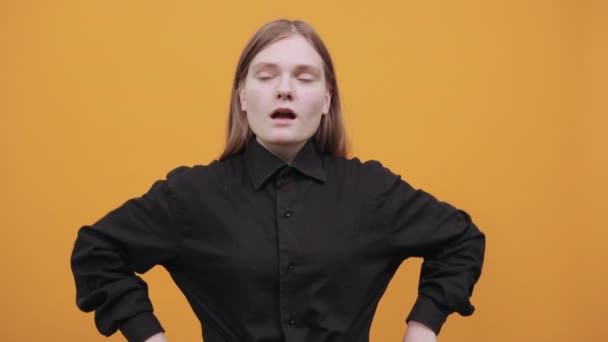 Blank vrouw in mode zwart shirt houden hand op riem, kijken naar camera — Stockvideo