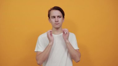 Sad boy in white t-short appearance touches her face with her hands dark hair