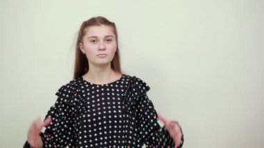 girl raised her hands up the hill and waits with certain gesture