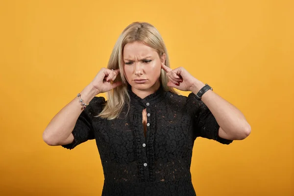 girl angry woman covered ears with fingers to avoid hearing sound of noise