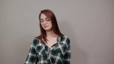 offended woman holds piece of paper with a red heart, negative attitude in hand