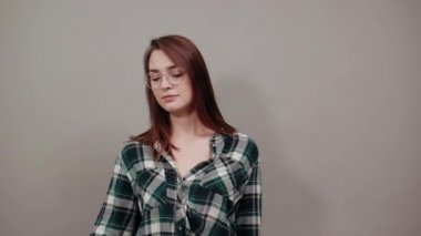 offended woman holds piece of paper with a red heart, negative attitude in hand
